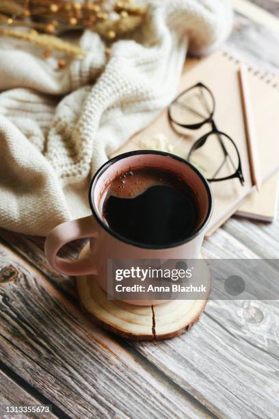 cozy home interior details, cup of coffee, eyeglasses and candles. dried flowers bunch. - coffee table reading mug stock pictures, royalty-free photos & images