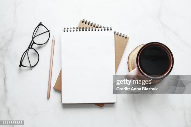 still life of note pad, eyeglasses, pencil and cup of coffee. copy space for text. creativity concept. - desk from above fotografías e imágenes de stock