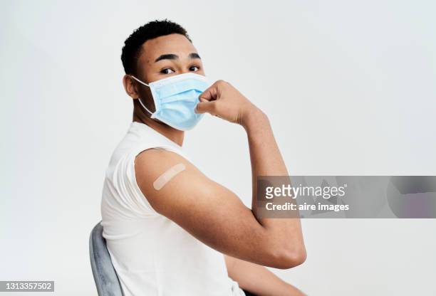 black boy shows the bandage on his arm with a gesture of strength and self-improvement and looking at camera - limb body part stock pictures, royalty-free photos & images