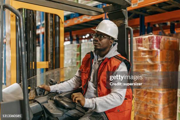 young attractive woman working in the warehouse - ware house worker forklift stock pictures, royalty-free photos & images