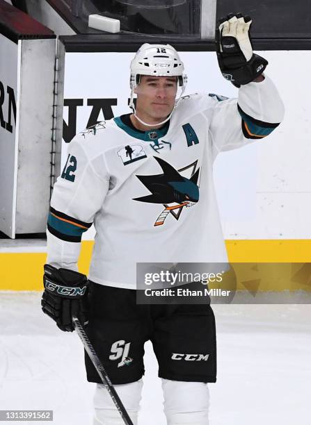 Patrick Marleau of the San Jose Sharks waves as he is honored as he plays in his 1,768th NHL game during a break in the first period against the...