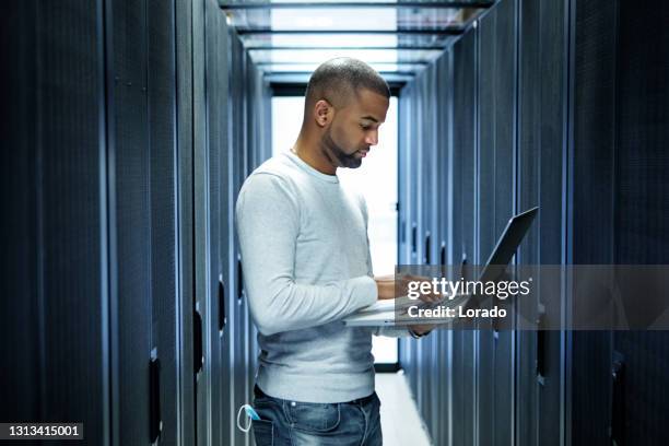 a black male server room technician working at business reopening - segurança do trabalho imagens e fotografias de stock