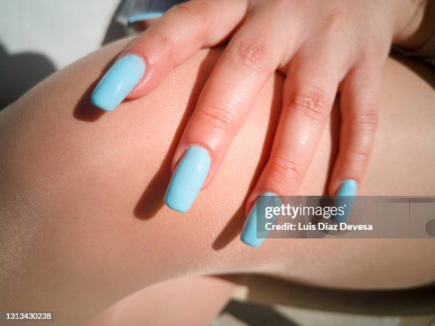 nails painted of blue on tanned skin of the leg - painting fingernails stock pictures, royalty-free photos & images