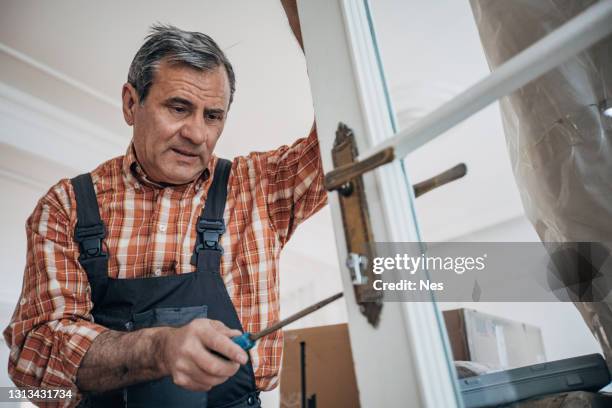 carpenter repairing the door - locksmith stock pictures, royalty-free photos & images