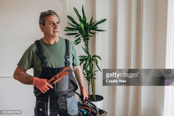 portrait of a smiling worker with work tools - holding tool stock pictures, royalty-free photos & images