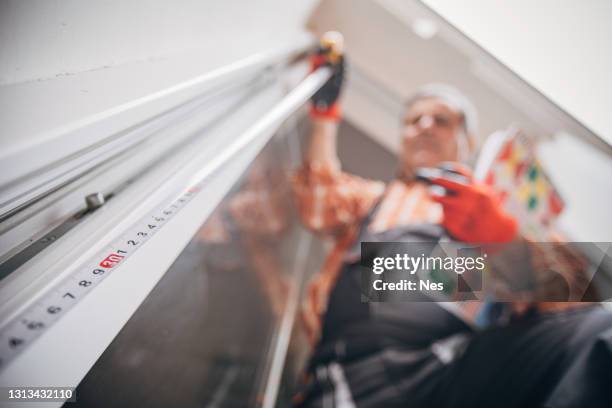 a construction worker installs windows - glazier stock pictures, royalty-free photos & images