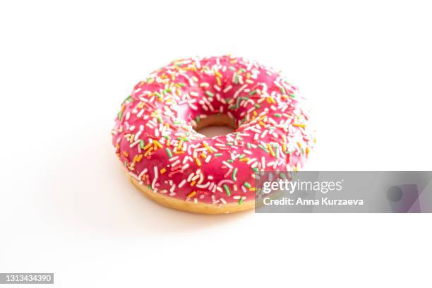 pink donut with colourful sprinkles isolated on white background - pink frosting stock pictures, royalty-free photos & images
