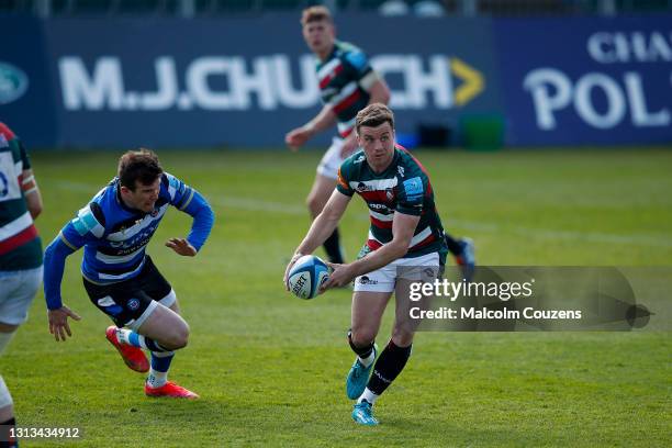 George Ford of Leicester Tigers avoids a tackle from Ben Spencer of Bath Rugby during the Gallagher Premiership Rugby match between Bath and...