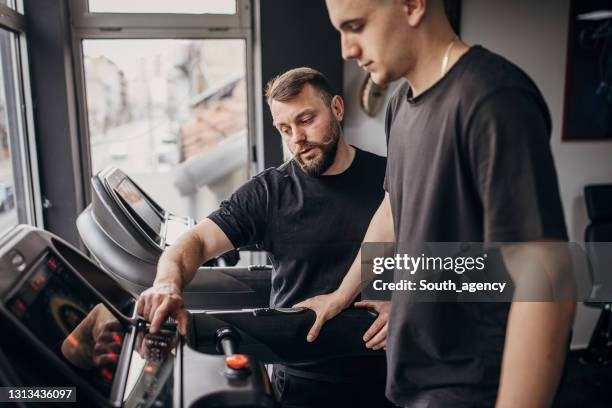 fitness instructor working with male client - running coach stock pictures, royalty-free photos & images