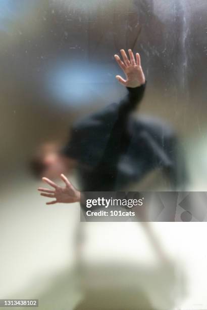 すりガラスの背後にある女性のジェスチャー恐怖 - frosted glass ストックフォトと画像