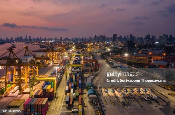 aerial view container cargo warehouse at terminal commercial port with cityscape background for business logistics, import export, shipping or freight transportation. - shipyard aerial stock pictures, royalty-free photos & images