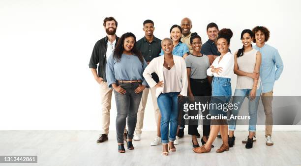 full length portrait of a diverse group of businesspeople standing together in the studio during the day - multiracial group stock pictures, royalty-free photos & images