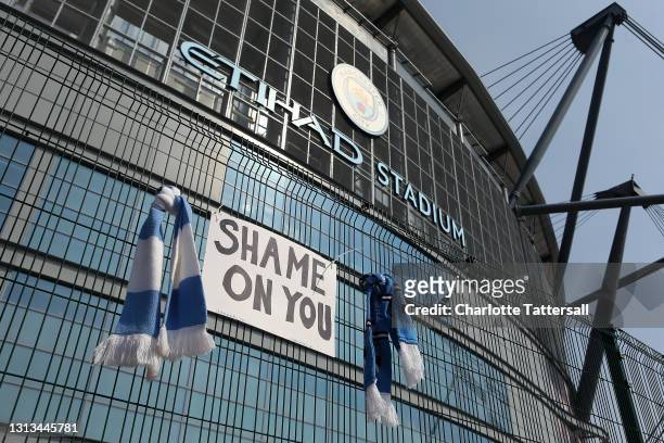 Sign which reads 'Shame On You' is placed between two Manchester City scarves outside the Etihad Stadium on April 20, 2021 in Manchester, England....