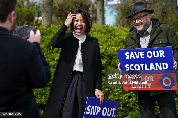 George Galloway leader of the All For Unity Party laughs with his wife Gayatri as he campaigns during the Scottish Parliament election with a speech...