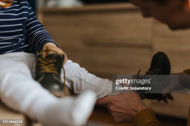 getting ready to go out - boy tying shoes stock pictures, royalty-free photos & images