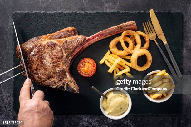 tomahawk steak with fries onion rings and bearnaise sauce being served - bearnaise stock pictures, royalty-free photos & images