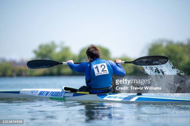 paraplegic athlete racing his kayak during a paracanoe competition - paraplegic race stock pictures, royalty-free photos & images
