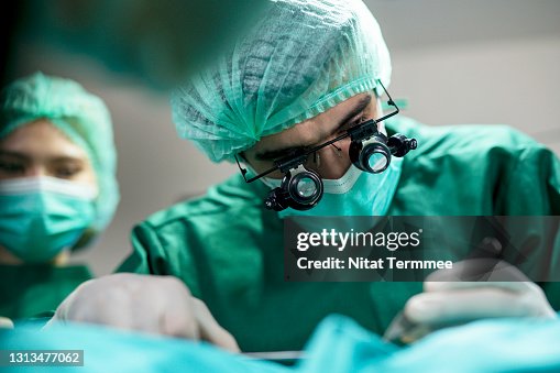 The Business of Plastic surgery. Surgeons operating patient for breast implant in Surgery Clinic. The Business of Plastic surgery. Surgeons operating patient for breast implant in Surgery Clinic.