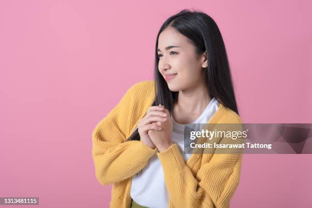 holding hands clasped in prayer, woman praying for forgiveness - confession religion stock pictures, royalty-free photos & images