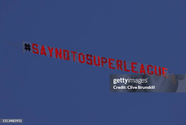 Sign is trailed by a plane with a slogan against a proposed new European Super League over the stadium during the warm up for the Premier League...