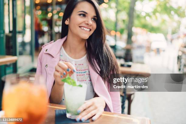woman enjoying the best mojito - mojito stock pictures, royalty-free photos & images