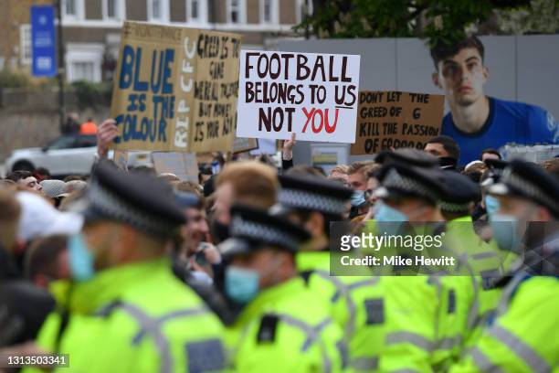 Police line up as Chelsea fans protest against the newly proposed European Super League prior to the Premier League match between Chelsea and...
