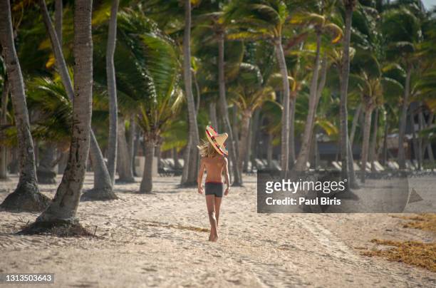 little boy with a sombrero hat  walking on the beach, riviera maya, mexico - beach music festival stock pictures, royalty-free photos & images