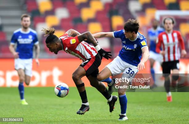 Ivan Toney of Brentford and Perry Ng of Cardiff City battle for the ball during the Sky Bet Championship match between Brentford and Cardiff City at...