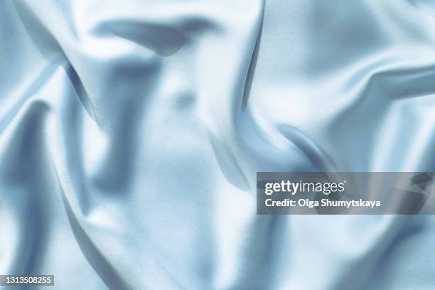 background of blue silk folds - silk foto e immagini stock