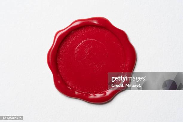 red colored sealing wax stamp on white paper - stamp imagens e fotografias de stock