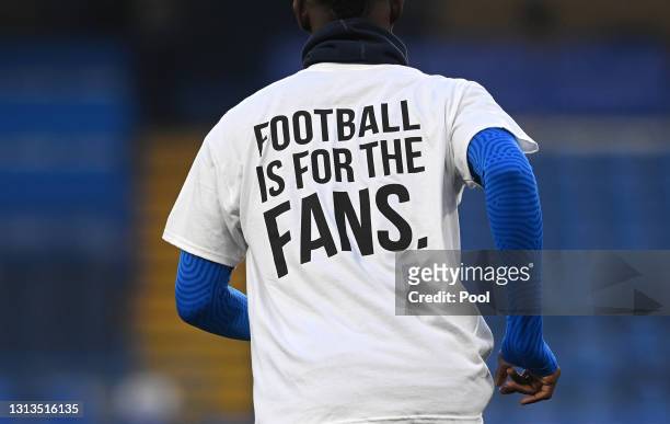 Detail view as Brighton & Hove Albion players warm up wearing a t-shirt with a message in protest against the European Super League prior to the...