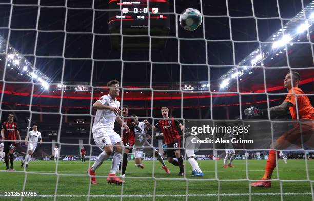 Martin Hinteregger of Eintracht Frankfurt scores their team's first goal past Rafal Gikiewicz of Augsburg during the Bundesliga match between...