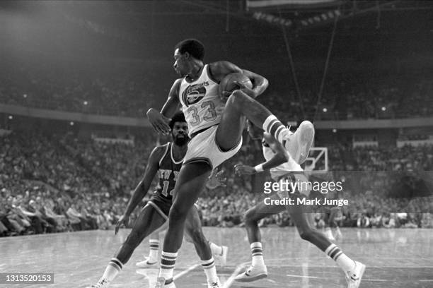 Denver Nuggets forward David Thompson tucks away a rebound in front of New York Knicks guard Ticky Burden during an NBA basketball game at McNichols...
