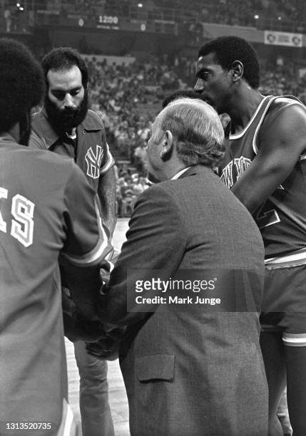 New York Knicks coach Red Holzman huddles with his team during an NBA basketball game against the Denver Nuggets at McNichols Arena on November 3,...