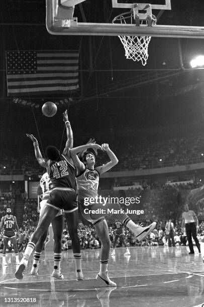 New York Knicks forward Spencer Haywood and Denver Nuggets forward Bobby Jones collide as they struggle for a rebound during an NBA basketball game...