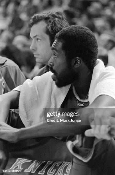 New York Knicks guard Earl Monroe sits on the bench draped by a towel during a game against the Denver Nuggets at McNichols Arena on November 3, 1976...