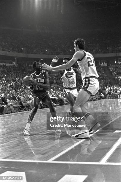 New York Knicks guard Earl Monroe is trapped near the lane by Denver Nuggets guard Ted McClain and forward Bobby Jones during an NBA basketball game...