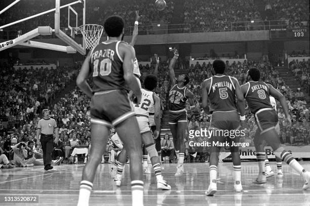 New York Knicks forward Spencer Haywood shoots a short jump shot over Denver Nuggets center Marvin Webster in the key during an NBA basketball game...