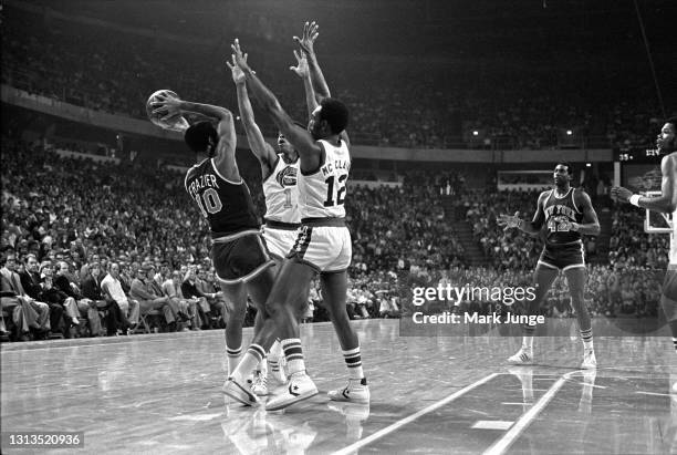 New York Knicks guard Walt Frazier is trapped by Denver Nuggets guards Chuck Williams and Ted McClain as he attempts a pass to his teammate Spencer...