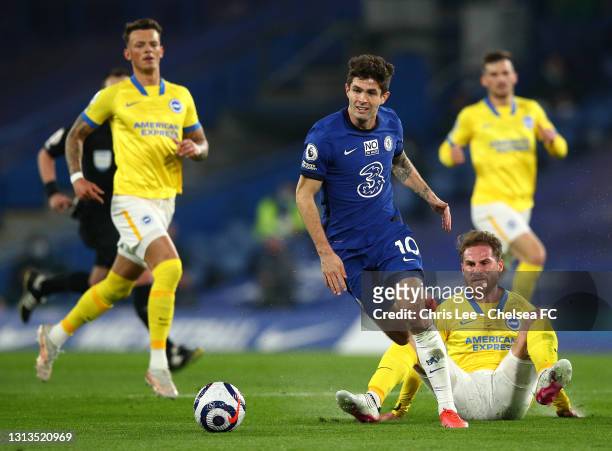 Christian Pulisic of Chelsea geta away from Alexis Mac Allister of Brighton & Hove Albion during the Premier League match between Chelsea and...