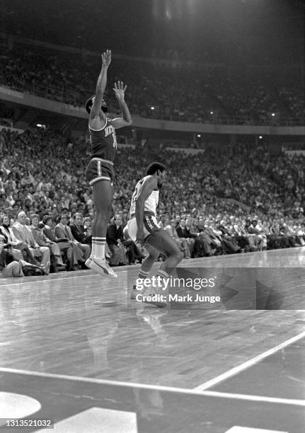 New York Knicks guard Walt Frazier shoots a jump shot over Denver Nuggets guard Ted McClain during an NBA basketball game at McNichols Arena on...