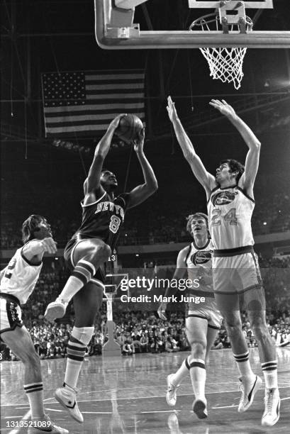 New York Knicks forward Lonnie Shelton drives to the hoop against Denver Nuggets forward Bobby Jones during an NBA basketball game at McNichols Arena...