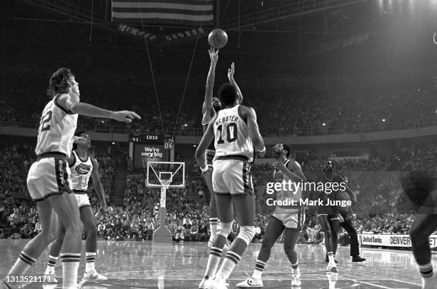 New York Knicks guard Walt Frazier shoots a jump shot from the free throw line during an NBA basketball game against the Denver Nuggets at McNichols...
