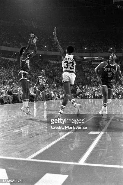 New York Knicks guard Ticky Burden shoots a jump shot over the outstretched arms of Denver Nuggets forward David Thompson during an NBA basketball...