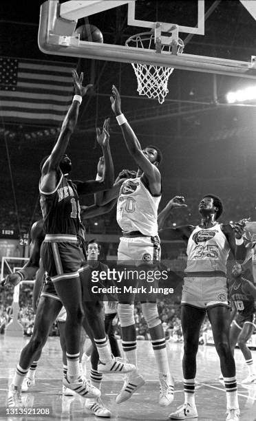 New York Knicks guard Earl Monroe shoots a layup against Denver Nuggets center Marvin Webster during an NBA basketball game at McNichols Arena on...