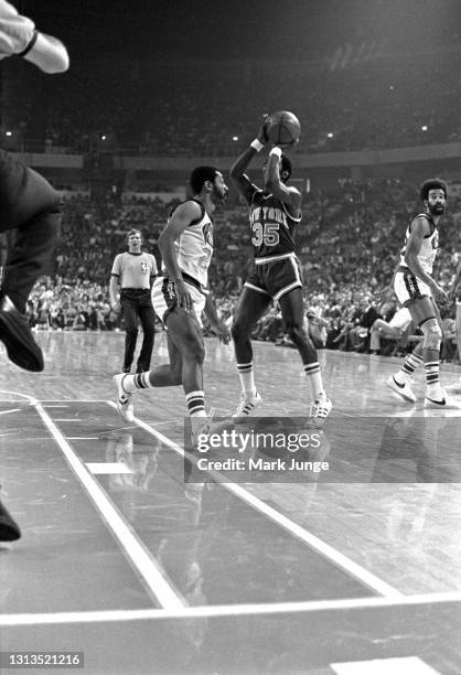 New York Knicks guard Mo Layton gets set for a jump shot against Denver Nuggets guard Fatty Taylor during an NBA basketball game at McNichols Arena...