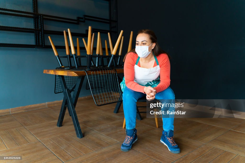 The waitress who closes the restaurant she works is sitting in a very pessimistic way