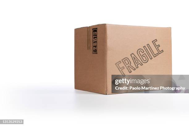 closed taped cardboard box on white background - carton box foto e immagini stock