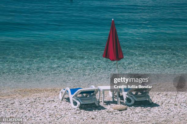 two sunbeds on the beach - mujeres hot stock pictures, royalty-free photos & images