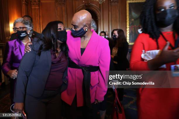 Rep. Cori Bush and Rep. Ayanna Pressley walk with their arms around each other as members of the Congressional Black Caucus walk to a news conference...